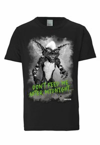 Black cotton t-shirt featuring a gremlin graphic in black and white with green text reading "DON'T FEED ME AFTER MIDNIGHT..."