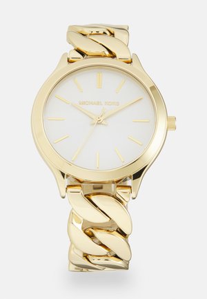 Gold-tone wristwatch with a white dial. Features a chunky chain-link bracelet and minimalist hour markers. Brand name displayed on the dial.