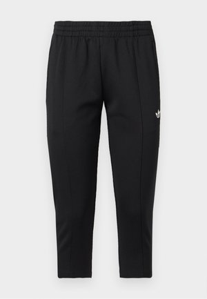 Black tapered sweatpants with elastic waistband and white Adidas logo on upper left thigh.