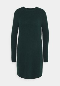 Robe pull longue à manches longues de couleur vert foncé, avec une texture côtelée et un col rond, présentant des fentes latérales en bas pour un meilleur confort de mouvement.