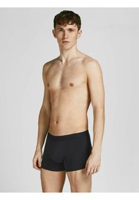 Schwarze Baumwoll-Boxershorts mit glatter Textur und elastischem Bund. Enganliegendes Design mit einem Beutel und kurzer Beinhöhe.