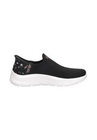 Zapatilla negra sin cordones con parte superior de malla texturizada, suela blanca y un acento floral en el talón. Presenta detalles del logo en el lateral.