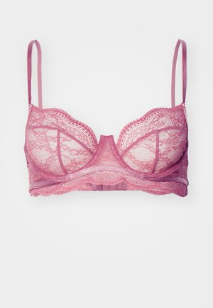 Lace bralette in muted pink with underwire support. Features adjustable straps and decorative scalloped edges. Translucent fabric detail.