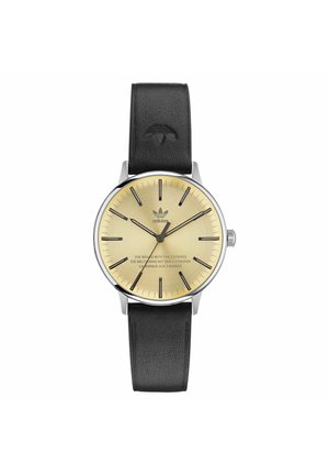 Round analog watch with a gold face, black hour markers, and silver casing. Black leather strap features embossed logo detail.