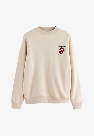 Bézs pulóver bordázott kerek nyakkal, hosszú ujjakkal és piros hímzett nyelv logóval. Puha anyag, laza szabás.