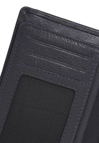 Navy leather wallet with textured exterior. Features multiple card slots and a mesh pocket. Clean stitching and sleek design.