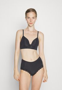 Black bra and high-waisted underwear set. Bra features a smooth texture and lace detail at the center; underwear has lace trim along the waist.