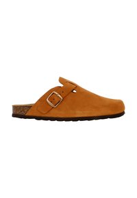 Suede clogs in a tan color with a cork footbed. Features a side buckle and rounded toe. Flat sole with traction.