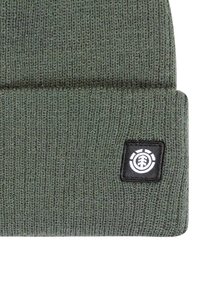 Green knitted beanie with a folded cuff, featuring a square black patch with a white emblem. The texture is ribbed and smooth.