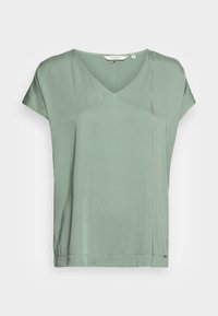 V-Ausschnitt Kurzarmshirt aus weichem, hellgrünem Stoff mit lässiger Passform. Beinhaltet dezente Nähte und einen leicht gerafften Saum.