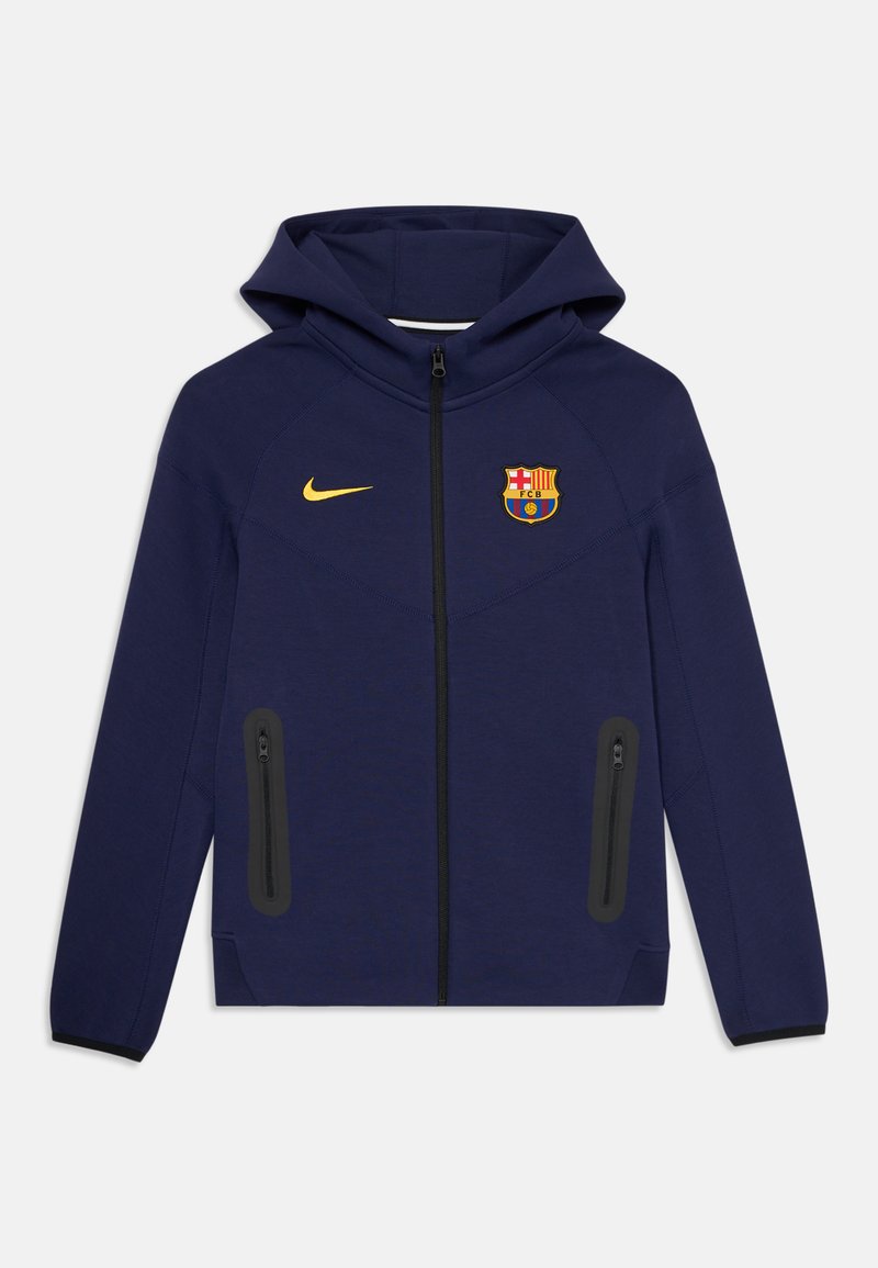 Tumši zili jaci ar kapuci, priekšējais rāvējslēdzis, melnas kabatas ar rāvējslēdzējiem, dzeltenais Nike logo un FC Barcelona emblēma uz krūšu.