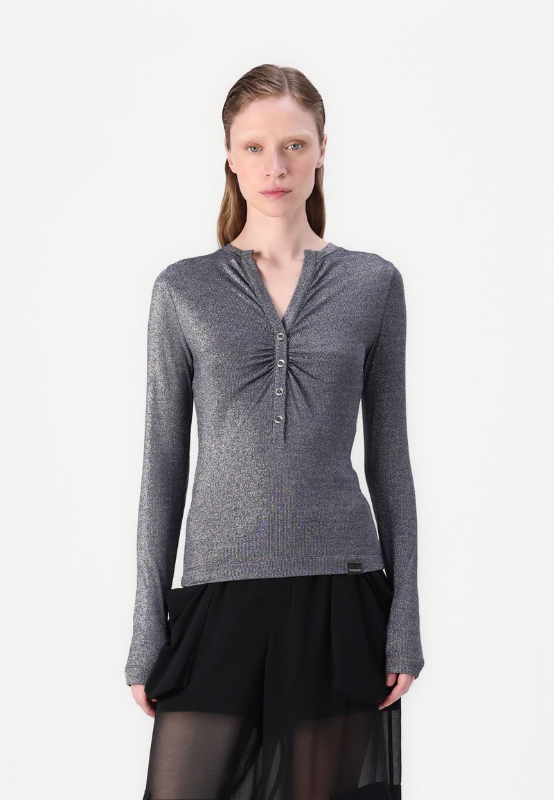 Silver-grey long-sleeve top with a henley neckline, gathered detail at chest, and five-button placket; soft, shiny fabric. Tag visible at the hem.