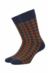 Skarpety w brązowo-granitowy wzór houndstooth z prążkowanym mankietem, wykonane z miękkiego, elastycznego materiału dla komfortu i dopasowania.