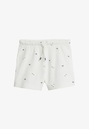 Białe bawełniane szorty o żeberkowej fakturze, z elastycznym paskiem i małymi wzorami w kolorze granatowym przedstawiającymi walenie i ptaki.