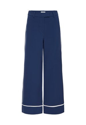 Pantalons larges bleu marine avec une texture lisse, comportant des passepoils blancs le long de l'ourlet et des coutures latérales, et une taille ajustée.