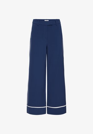 Pantalons larges bleu marine avec une texture lisse, comportant des passepoils blancs le long de l'ourlet et des coutures latérales, et une taille ajustée.