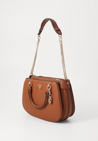 Borsa a tracolla sintetica marrone con due manici superiori, accentuazione in catena dorata, chiusura a zip e dettaglio del logo triangolare sulla parte anteriore. Texture liscia.