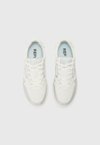 White sneakers with a smooth leather upper, perforated toe, translucent iridescent accents, and light blue insoles featuring text.