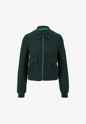 Dunkelgrüne Bomberjacke aus strukturiertem Stoff, mit Frontreißverschluss, zwei aufgesetzten Taschen, gerippten Bündchen und Saum. Verfügt über einen Kragen und ein Markenlabel im Inneren.