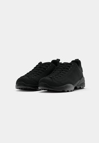 Black hiking shoes with a textured upper, reinforced toe, and rubber sole. Features a lace-up design and padded collar for comfort.