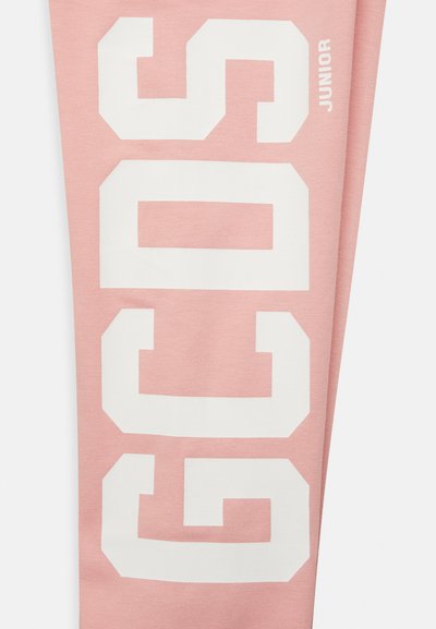 Leggings rosas em algodão com texto branco em destaque "GCOS" e "JUNIOR" em estilo atlético. Textura suave com design ajustado.