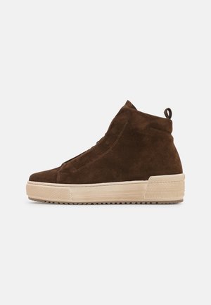 Brązowy zamszowy wysokogatunkowy sneaker z grubą beżową gumową podeszwą i pętelką z tyłu, pokazany z zewnętrznej strony na białym tle.