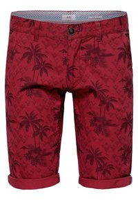 Shorts rouges avec un motif de palmier, en coton, dotés d'une fermeture à bouton et de revers roulés. L'intérieur présente un design rayé.