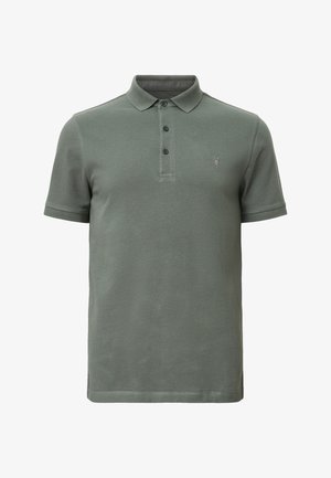 Polo en vert olive en coton, avec une patte de boutonnage à trois boutons, des manches courtes et un petit logo brodé sur la poitrine gauche.