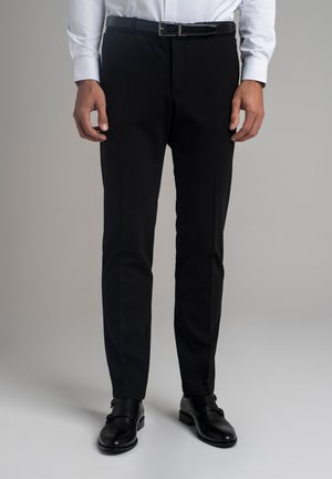 - Spodnie materiałowe