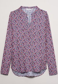 Blouse à manches longues avec un motif géométrique violet, rose et bleu. Dotée d'un col sans col et d'un ourlet arrondi. Confectionnée en tissu léger.