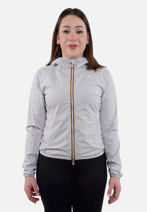 Giacca con zip grigia chiara con cappuccio, caratterizzata da una zip colorata e polsini elastici, realizzata in un materiale morbido e leggero.