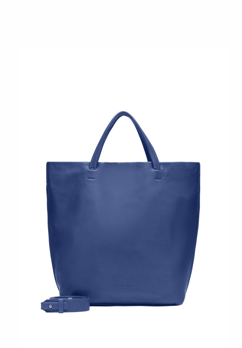 Sac fourre-tout en cuir bleu avec deux poignées et une bandoulière amovible. Texture lisse, design minimaliste et détail de marque à l'avant.