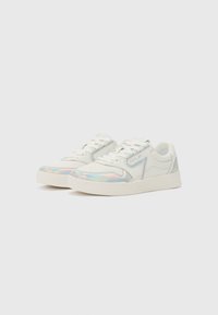 White sneakers with iridescent accents, textured synthetic material, and a flat rubber sole; features a lace-up design and perforated detailing.