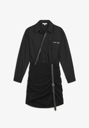 Zwarte jurk met een kraag en lange mouwen, een geraffineerde rok en een verstelbare riem met een gesp aan de zijkant.