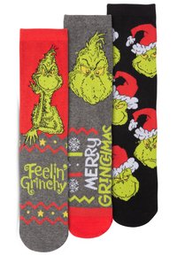 Tre paia di calzini con il Grinch. Colori: rosso, grigio, nero. I design includono facce del Grinch e frasi festive in caratteri bold.