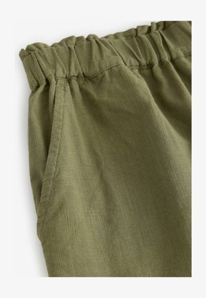 Roheline linane püksid, millel on elastne vöökoht, tekstureeritud kangas ja küljetaskud. Kujundus on lihtne ja mugav.