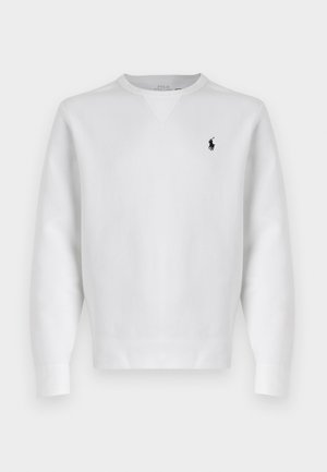 Sudadera blanca de algodón con cuello redondo y mangas largas, que presenta un pequeño logotipo negro en el lado izquierdo del pecho. Textura suave y diseño clásico.