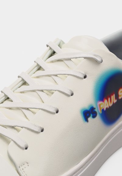 Baskets blanches avec lacets blancs et logo "PS PAUL SMITH" en bleu et rouge sur le côté près de la cheville.