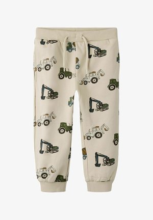 Bēša krāsas bērnu skriešanas bikses ar zaļu un baltu būvmašīnu rakstiem, elastīgu jostu ar auklu un aprocēm pie potītēm.