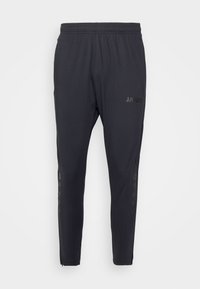Schwarze Sporthose aus leichtem Material, mit elastischem Bund und seitlichen Logoakzenten. Enger Schnitt und mit Reißverschlüssen an den Säumen.