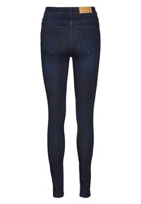 Σκούρο μπλέ skinny τζιν φτιαγμένα από τζιν ύφασμα, με μεσαία μέση, δύο πίσω τσέπες και μια καφέ δερμάτινη ετικέτα στη ζώνη.