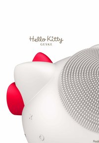 Weißes, rundes Gerät mit strukturierten Oberflächen. Verfügt über rote Akzente und Bedienelemente. Die Marke "Hello Kitty GESKE" ist darüber angezeigt.