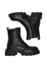 Czarne skórzane botki za kostkę z grubymi podeszwami, wiązane z przodu i zamkiem błyskawicznym z boku; cechują się fakturowanym wykończeniem i solidnymi szwami.