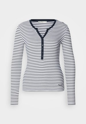 Valge ja tumesinise triibuline pika varrukaga top. Disainis on V-kaelus, nööpdetailid ja sooniline tekstuur koos logoga alumisel äärel.