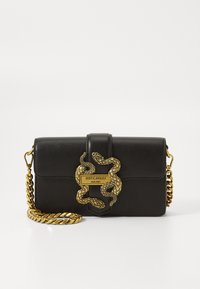 Black leather handbag with a gold snake motif and chain strap. Features a prominent logo plate. Compact rectangular shape.