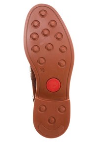 Semelle en caoutchouc marron avec des motifs de grip circulaires, arborant un logo circulaire rouge au centre et un bord texturé lisse. Taille marquée comme 41.