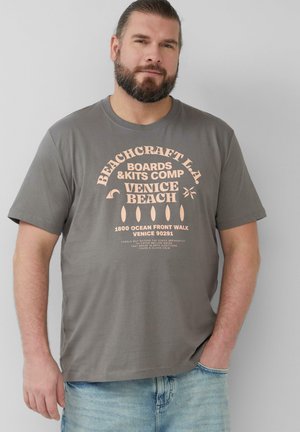 Grijze T-shirt met lichtroze tekst met een strandthema. De tekst bevat "Beachcraft L.A." en "Venice Beach." Korte mouwen en een ontspannen pasvorm.