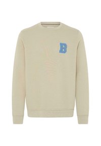 Beige mikina s dlouhými rukávy, žebrovanými manžetami a lemem. Na levé straně hrudi má vyšitý modrý "B". Měkká textura látky.