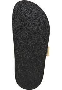 Zwarte textuur van de zool van een sandaal met een ronde vorm en een metalen accent aan de zijkant, ontworpen voor slip-on gebruik.