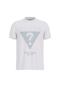 Camiseta blanca de algodón con un triángulo contorneado en azul con un signo de interrogación y el texto "Tradición Atemporal Desde 1981". Mangas cortas, escote redondo.